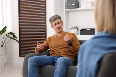 Photo of Professional psychologist working with patient in office