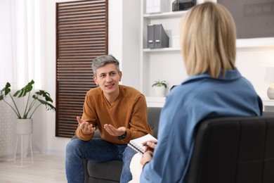 Photo of Professional psychologist working with patient in office