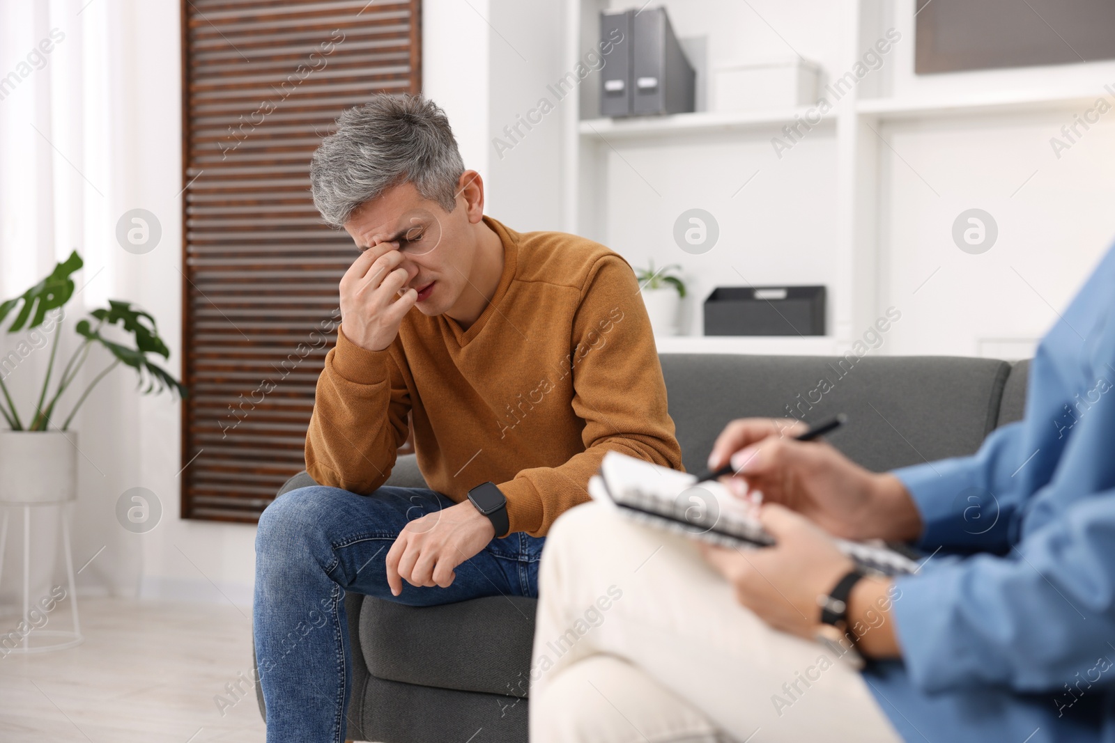 Photo of Professional psychologist working with patient in office, closeup