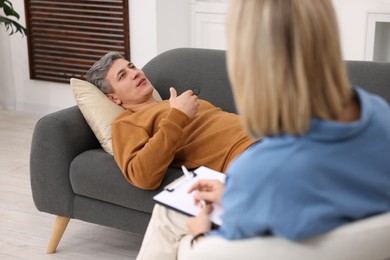 Photo of Professional psychologist working with patient in office