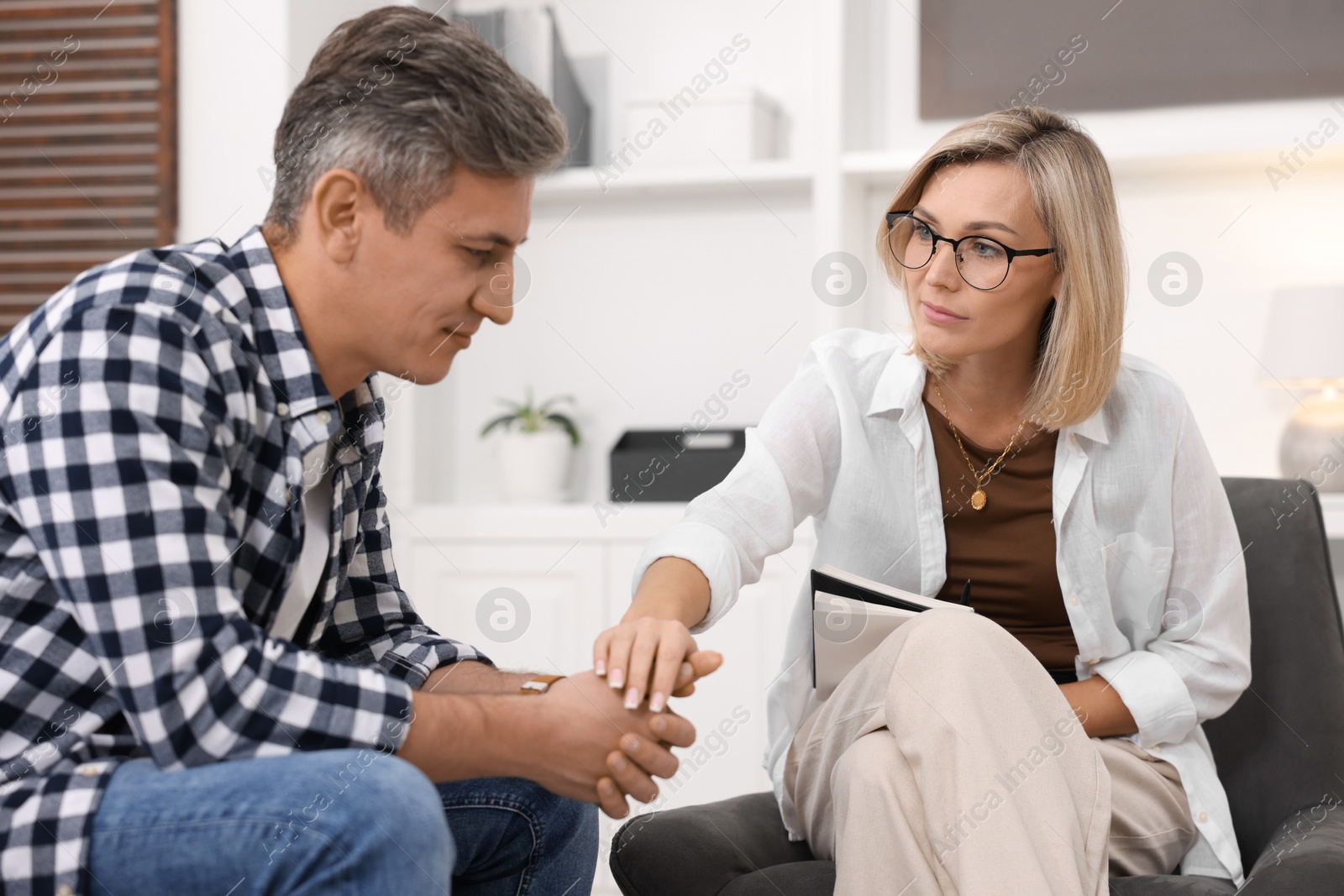 Photo of Professional psychologist working with patient in office