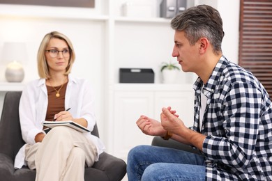 Photo of Professional psychologist working with patient in office