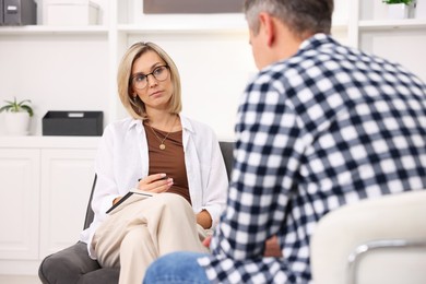 Photo of Professional psychologist working with patient in office