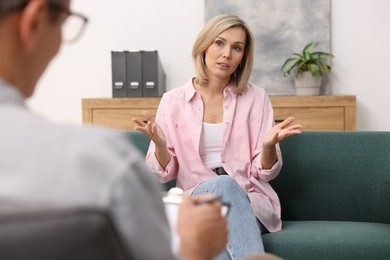 Photo of Professional psychologist working with patient in office, closeup