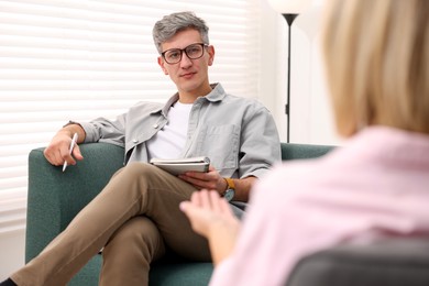 Photo of Professional psychologist working with patient in office