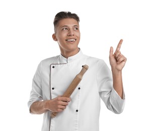 Photo of Professional chef with rolling pin pointing at something on white background