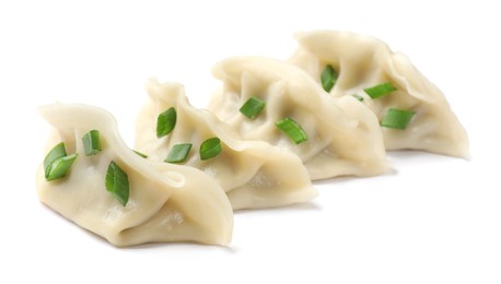 Photo of Fresh gyoza dumplings with pieces of green onion isolated on white