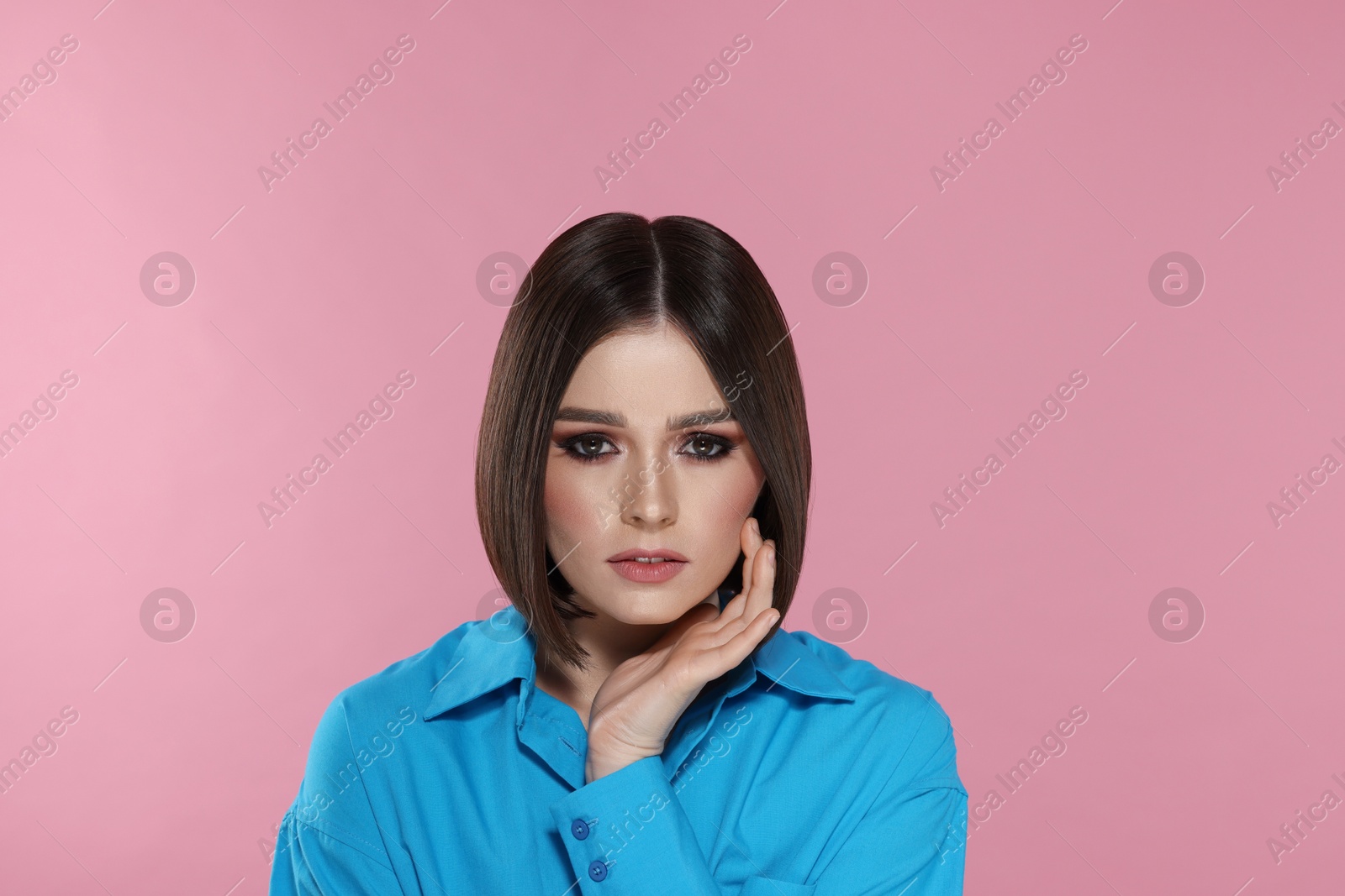 Photo of Portrait of beautiful young woman with gorgeous straight hair on pink background