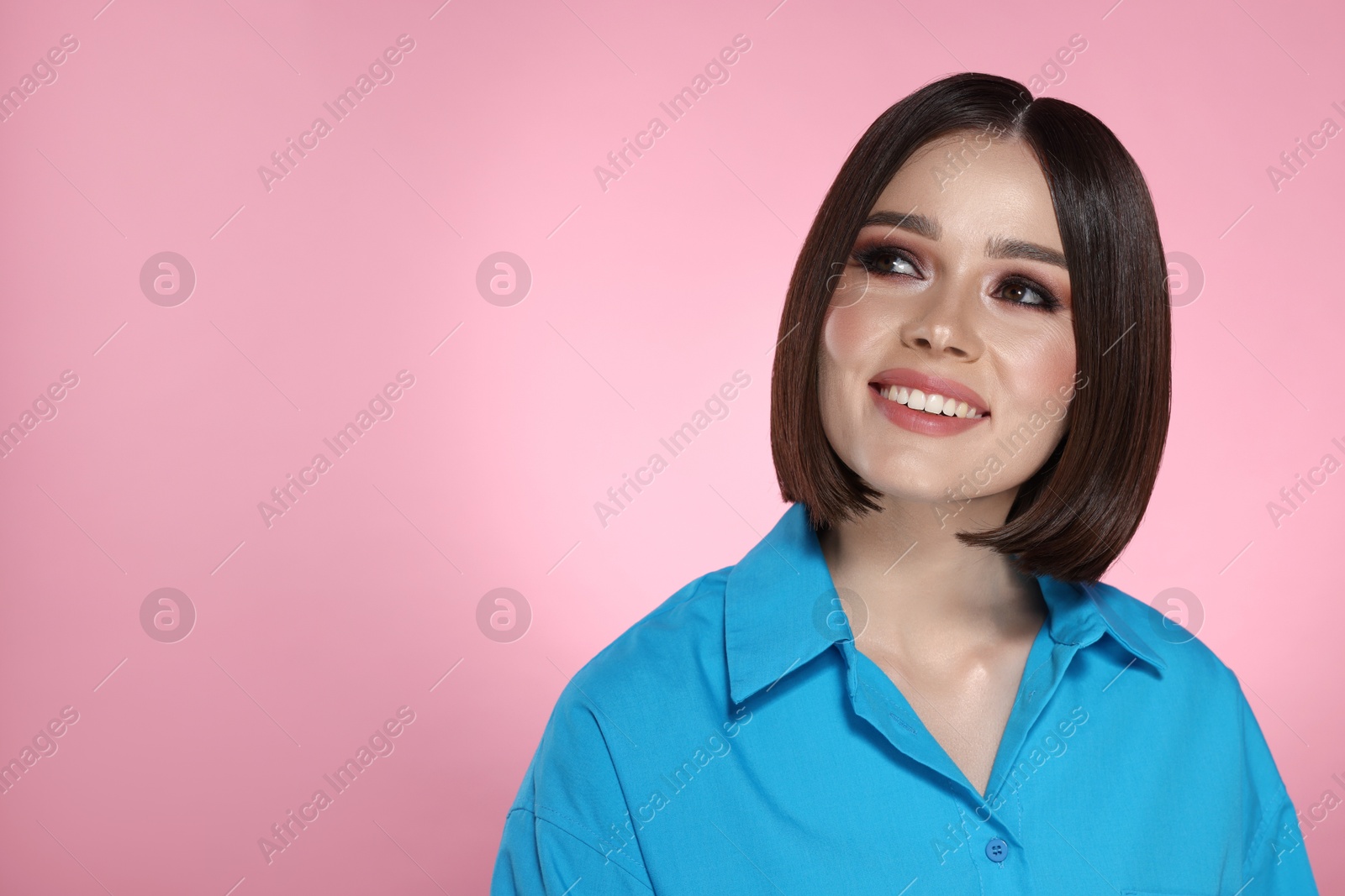 Photo of Portrait of beautiful young happy woman with gorgeous straight hair on pink background, space for text