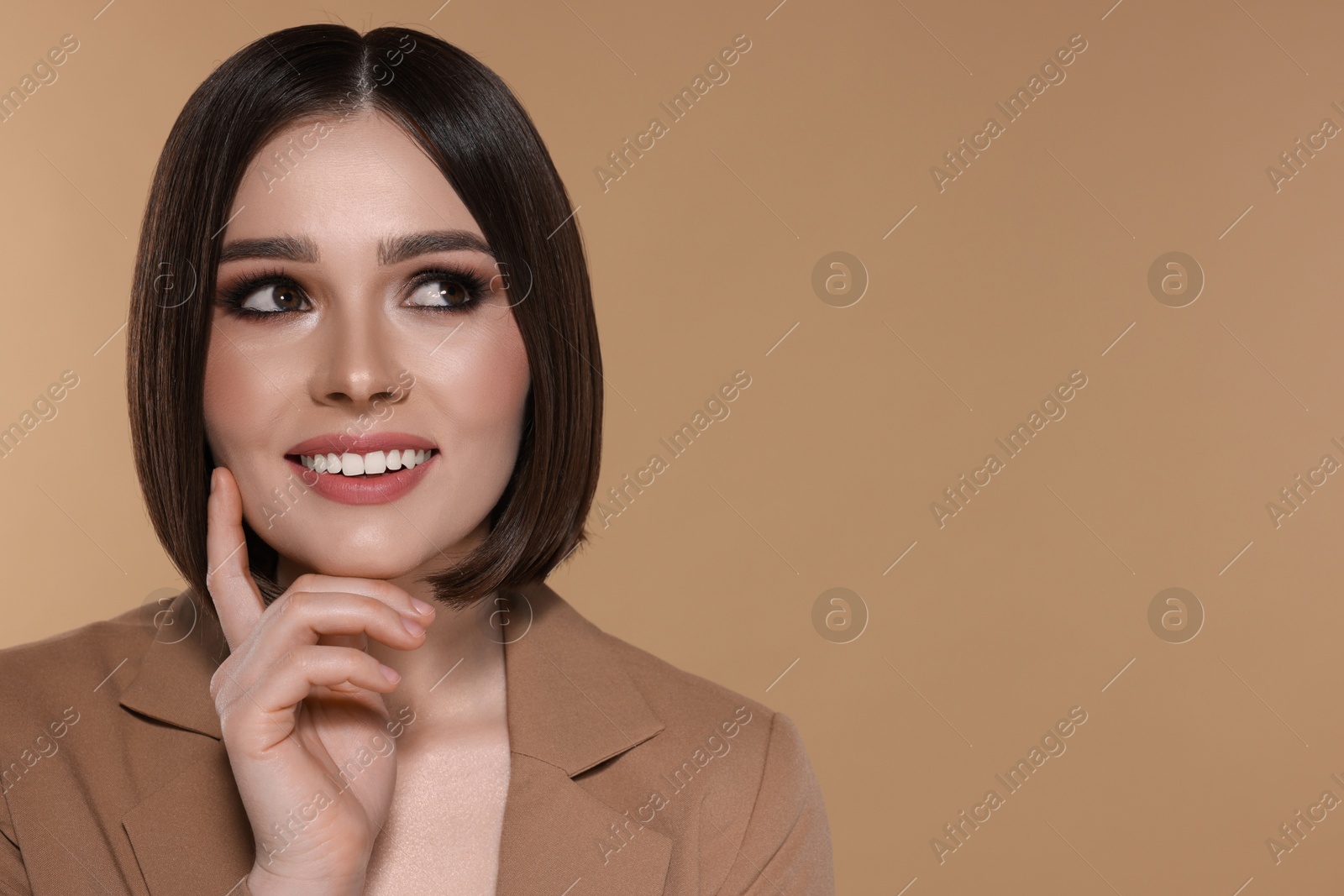 Photo of Portrait of beautiful young happy woman with gorgeous straight hair on beige background, space for text