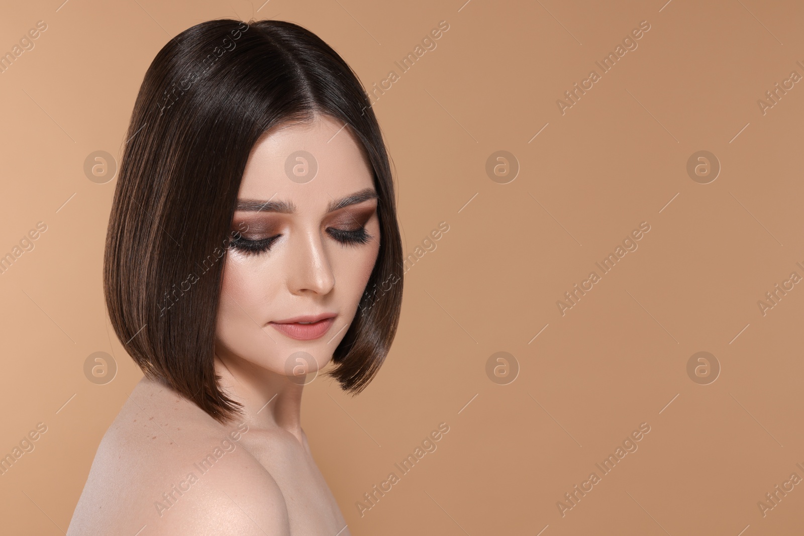 Photo of Portrait of beautiful young woman with gorgeous straight hair and stylish makeup on beige background, space for text