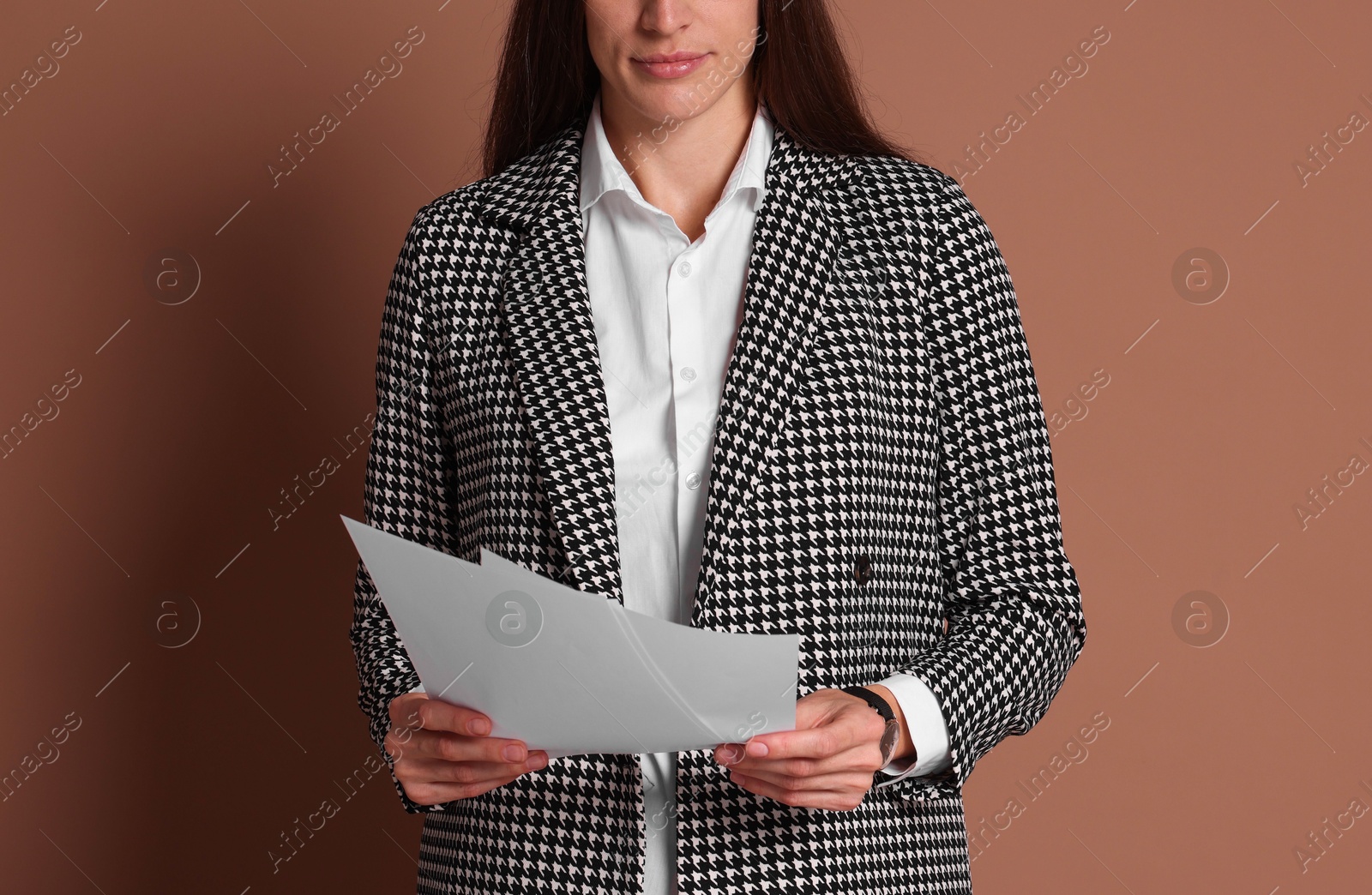 Photo of Portrait of banker with documents on brown background