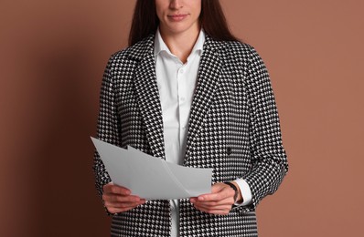 Photo of Portrait of banker with documents on brown background