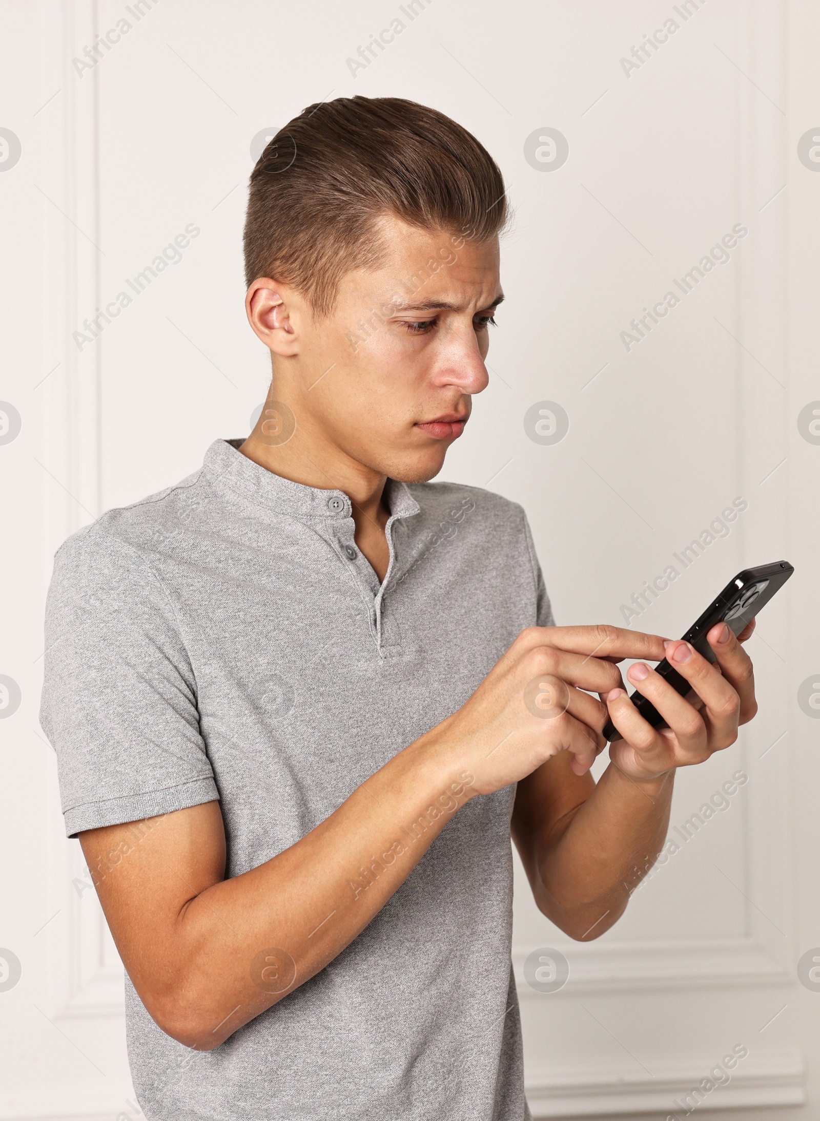 Photo of Frustrated man calling hotline for mental health help indoors. Space for text