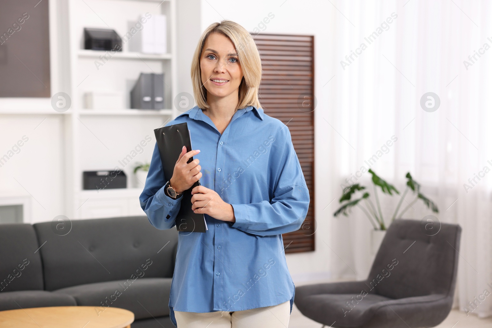 Photo of Portrait of professional psychologist with clipboard in office