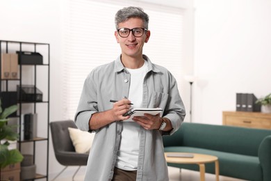 Photo of Portrait of professional psychologist with notebook in office