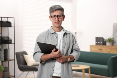 Photo of Portrait of professional psychologist with clipboard in office