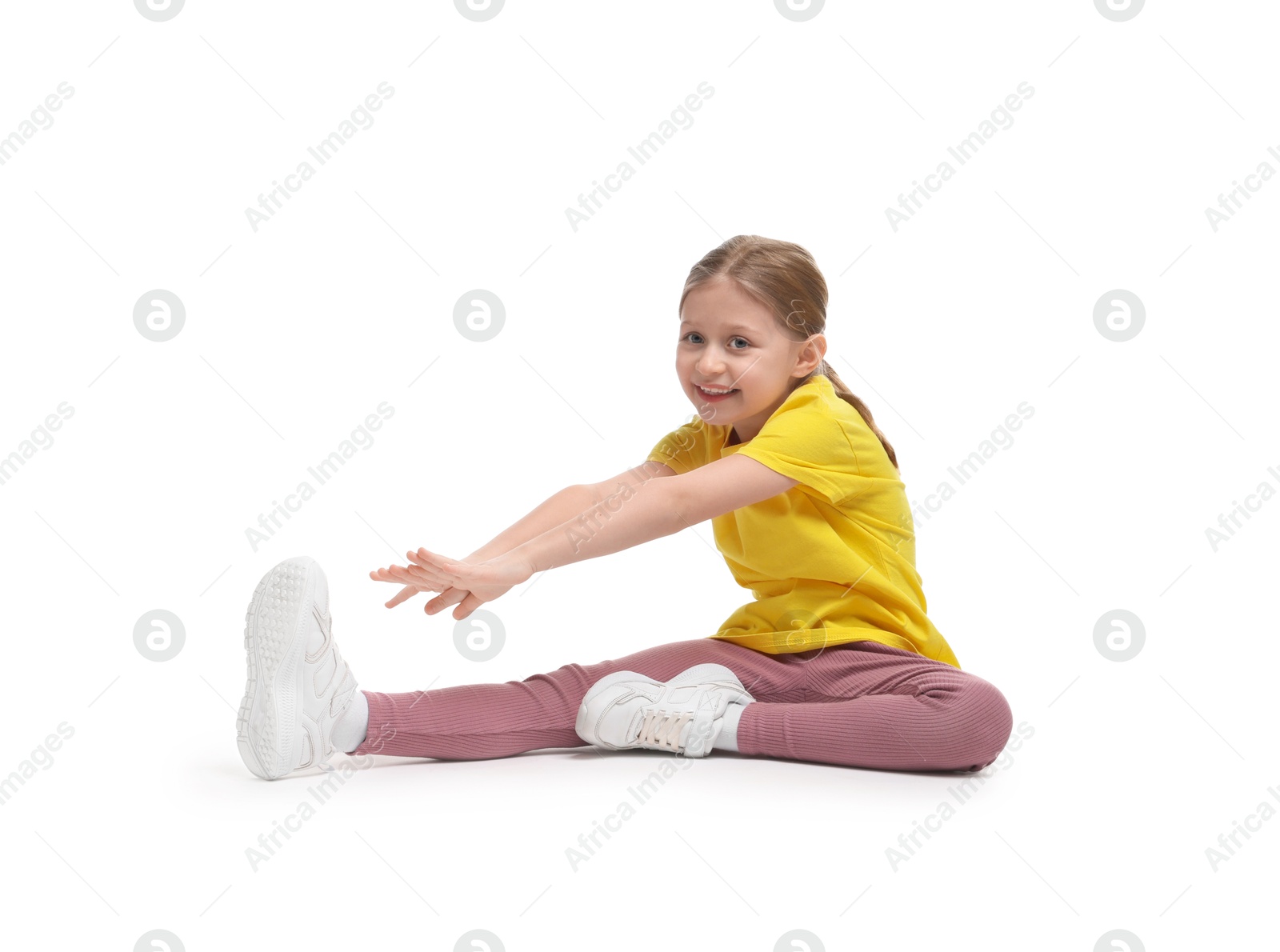 Photo of Cute little girl exercising on white background