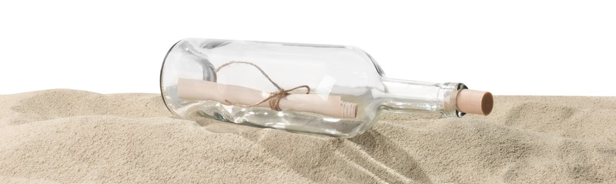 Photo of Rolled letter in corked glass bottle on sand against white background