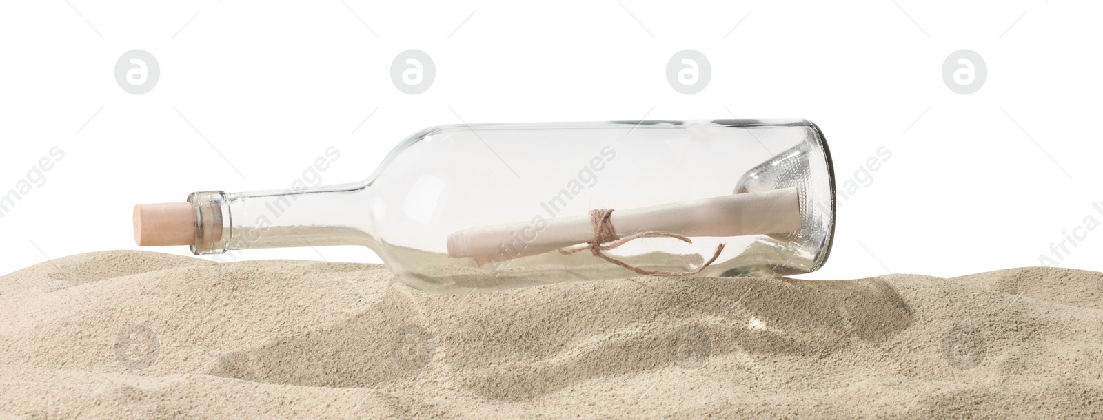 Photo of Rolled letter in corked glass bottle on sand against white background