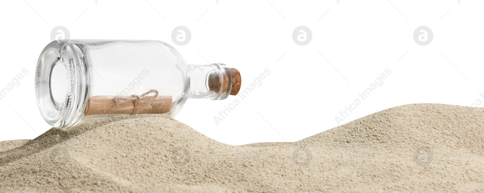 Photo of Rolled letter in corked glass bottle on sand against white background