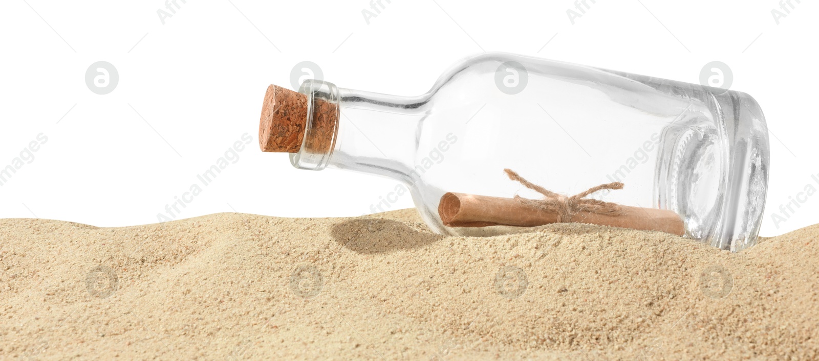 Photo of Rolled letter in corked glass bottle on sand against white background