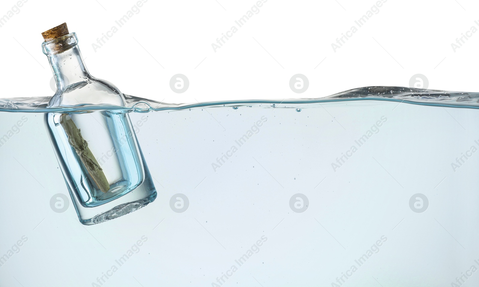 Photo of Corked glass bottle with rolled letter in water on white background