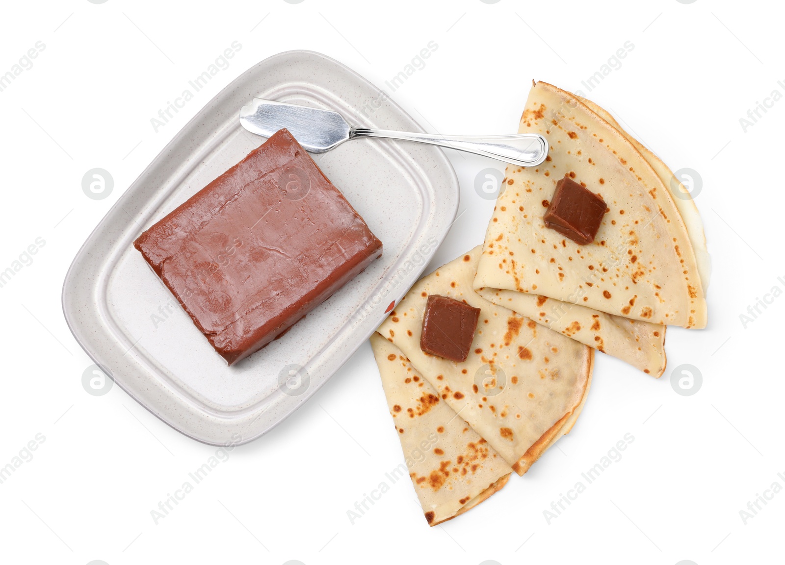 Photo of Tasty crepes with chocolate butter and knife isolated on white, top view