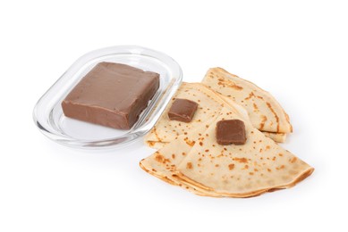 Photo of Tasty crepes with chocolate butter isolated on white