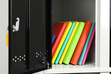 Photo of Lockers with school supplies on light background, closeup