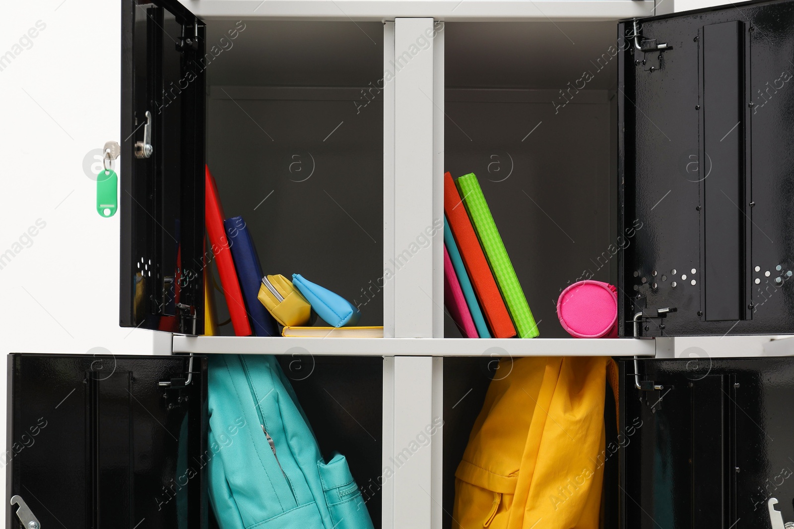 Photo of Lockers with school supplies on light background, closeup