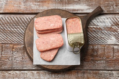 Tasty canned meat on wooden table, top view