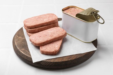 Photo of Tasty canned meat on white table, closeup