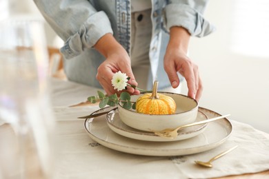 Photo of Woman setting table for dinner at home, closeup