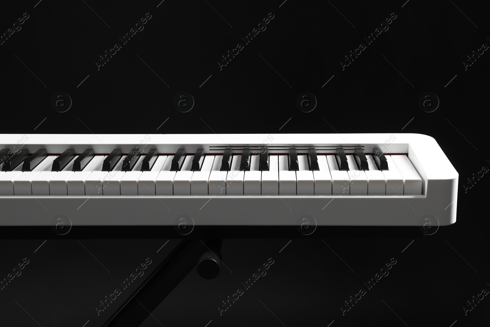 Photo of Synthesizer on black background, closeup. Electronic musical instrument