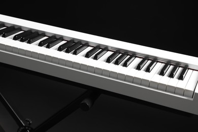 Photo of Synthesizer on black background, closeup. Electronic musical instrument