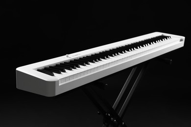 Photo of Synthesizer on black background, closeup. Electronic musical instrument