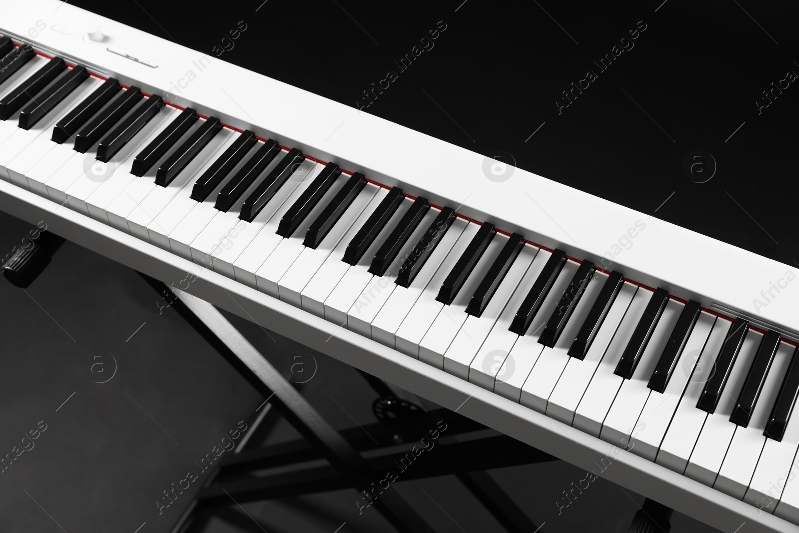 Photo of Synthesizer on black background, closeup. Electronic musical instrument