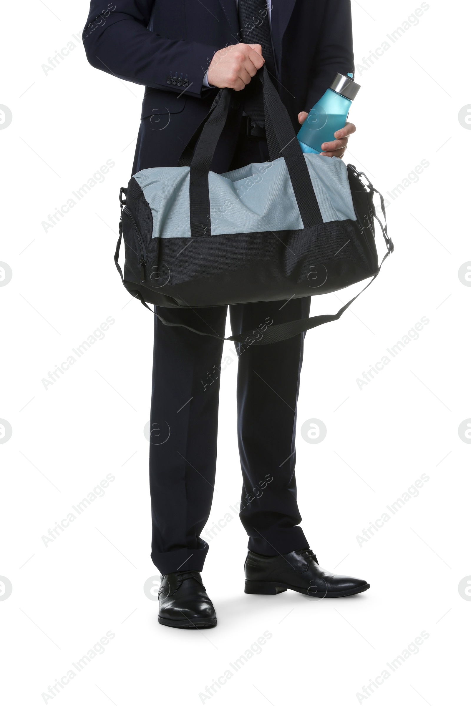 Photo of Man in suit putting bottle of water into gym bag on white background, closeup