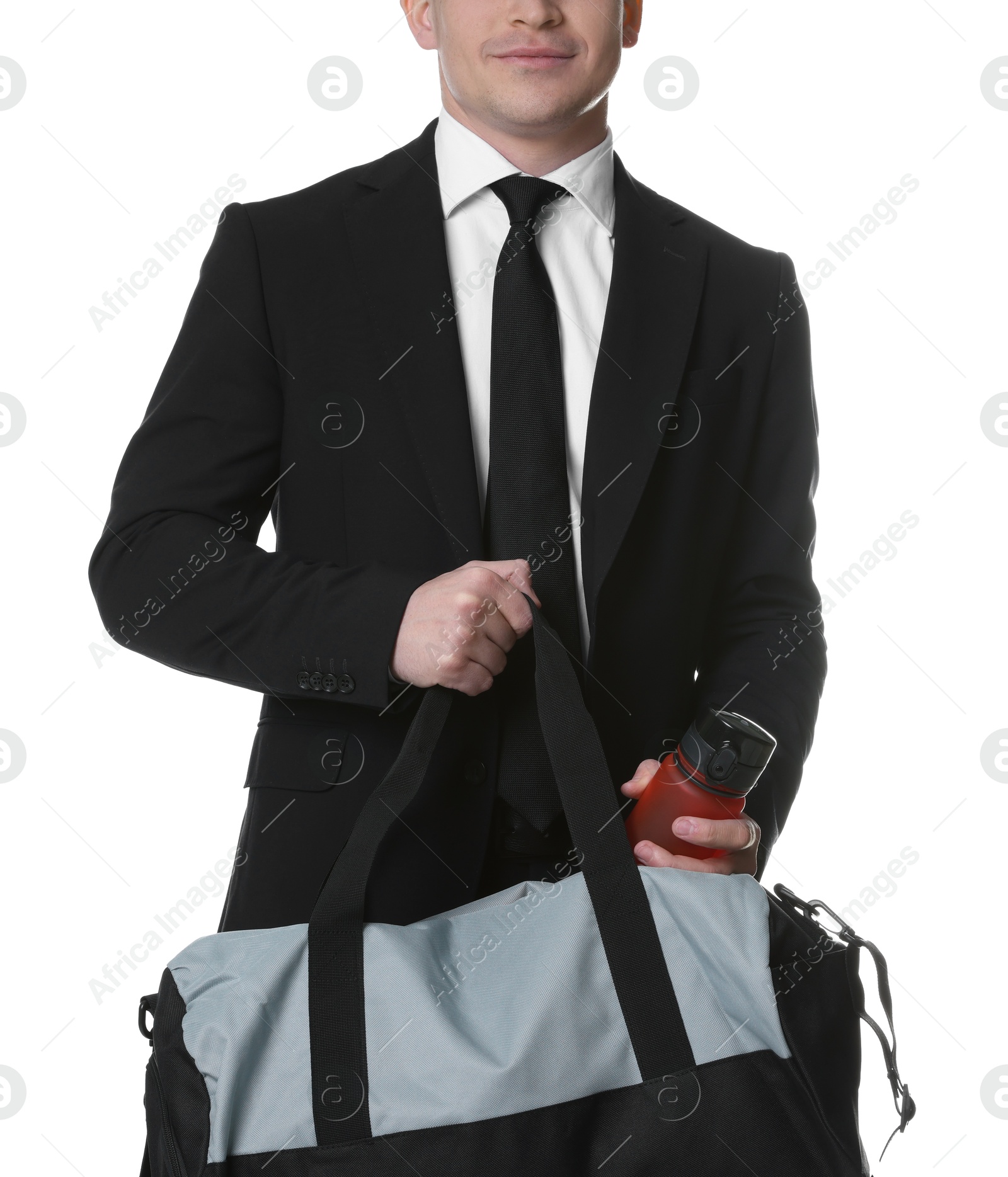 Photo of Man in suit putting bottle of water into gym bag on white background, closeup