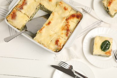 Photo of Delicious spinach lasagne served on white wooden table, flat lay