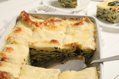 Photo of Delicious spinach lasagne on white table, closeup