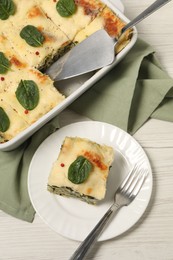 Photo of Delicious spinach lasagne served on white wooden table, flat lay