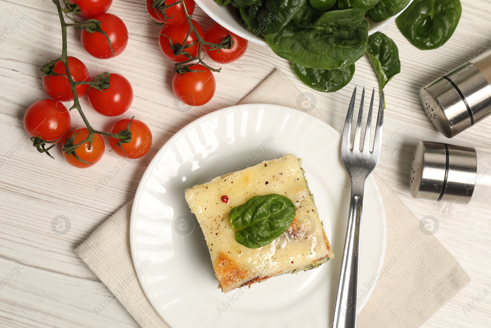 Photo of Delicious spinach lasagne served on white wooden table, flat lay