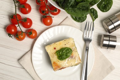 Photo of Delicious spinach lasagne served on white wooden table, flat lay