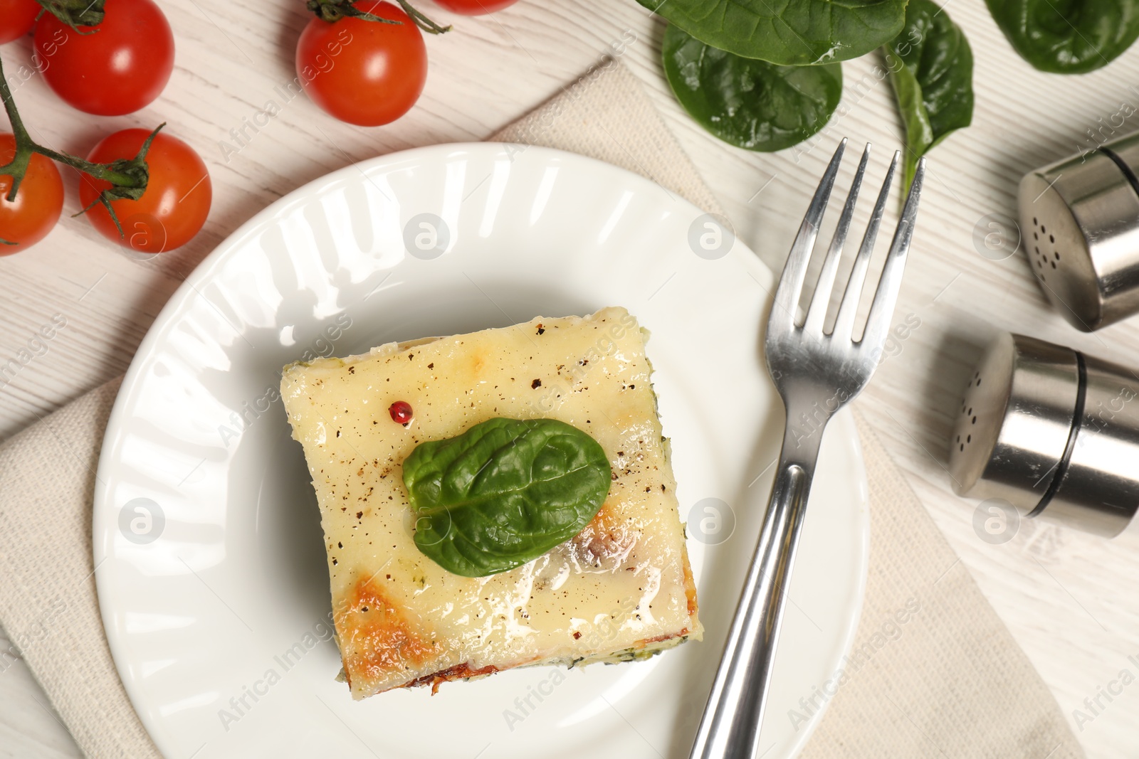 Photo of Delicious spinach lasagne served on white wooden table, flat lay