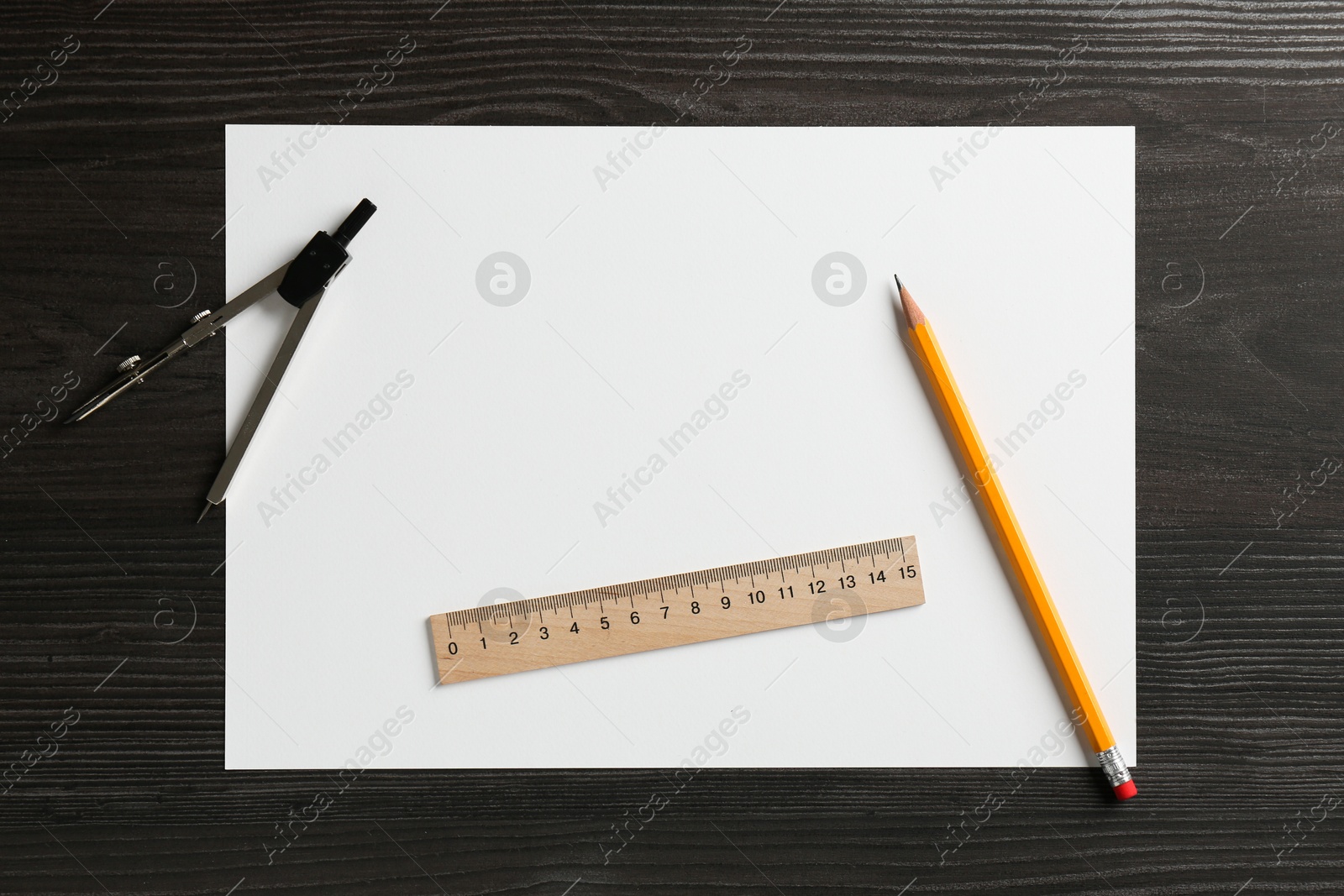 Photo of Ruler, paper, compass and pencil on black wooden table, flat lay. Space for text