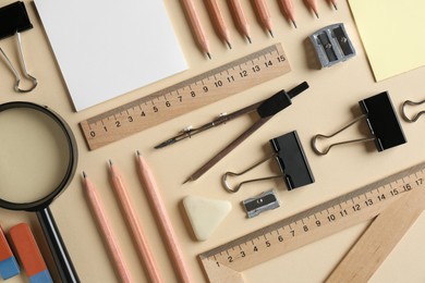 Photo of Flat lay composition with ruler and other stationery on beige background