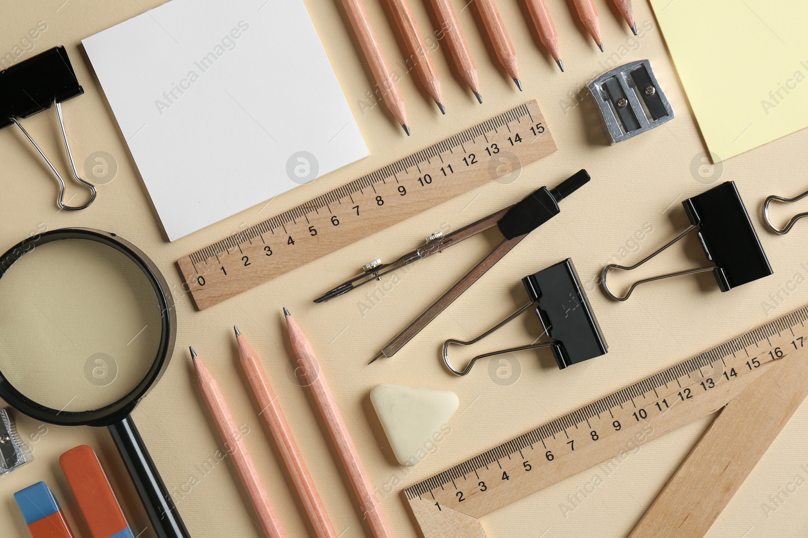 Photo of Flat lay composition with ruler and other stationery on beige background