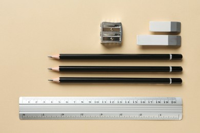 Photo of Flat lay composition with ruler and other stationery on beige background